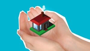 A hand holding a house model