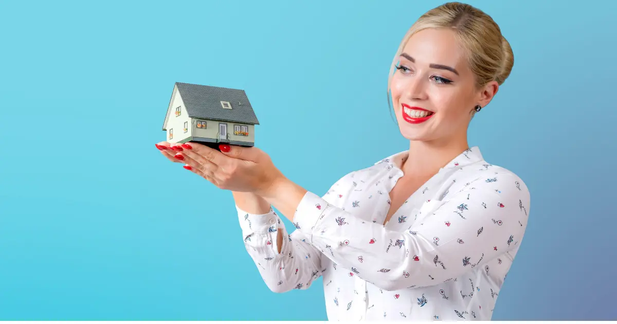 A girl holding a house model