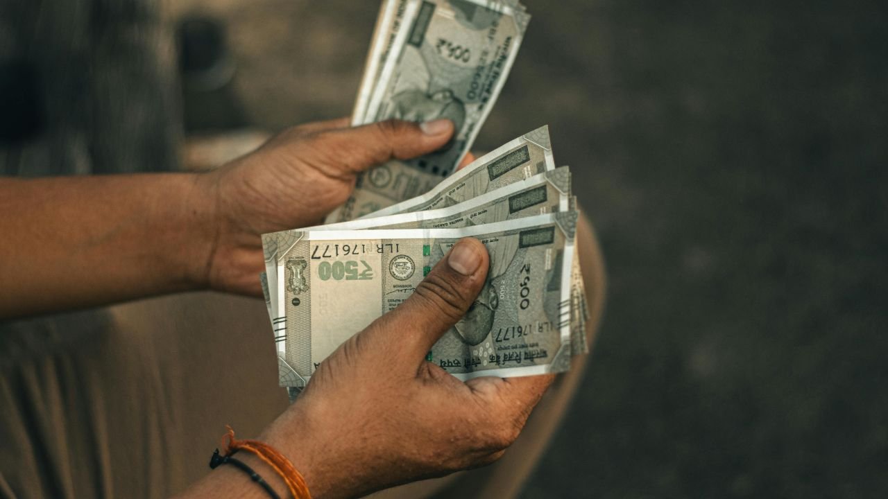 Some five hundred rupees notes on hands shown as countiing